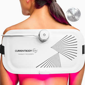 CurrentBody LED Light Therapy Panel on woman's back for pain relief and skin treatment